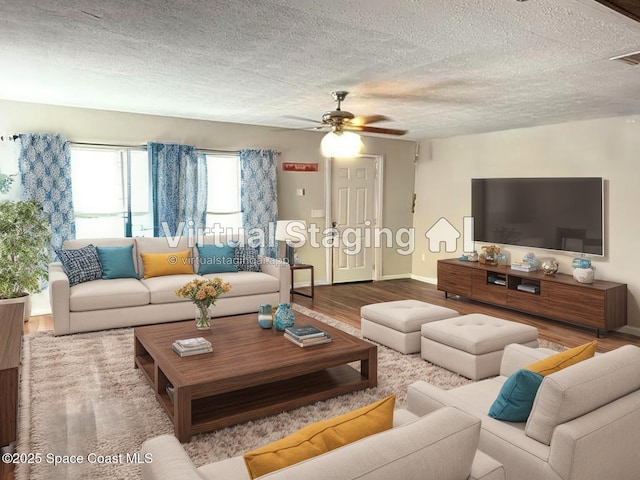225 Court St, Titusville, FL 32780 - living room with wood finished floors, ceiling fan, baseboards, and a textured ceiling