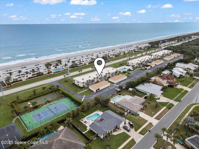 birds eye view of property featuring a water view and a beach view