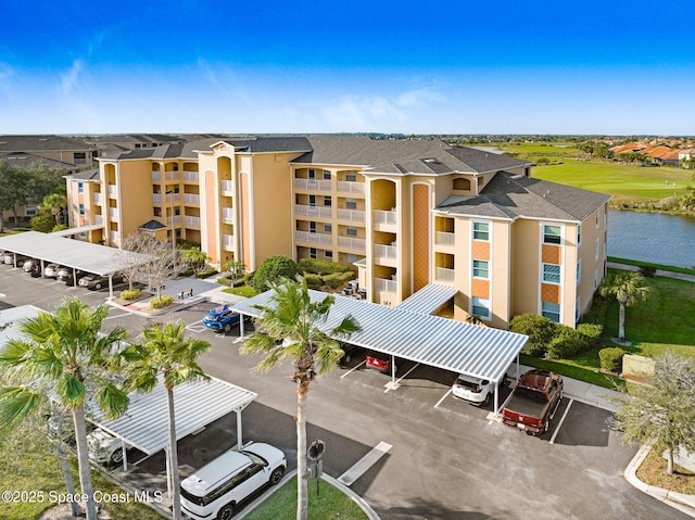 view of property with a water view and uncovered parking