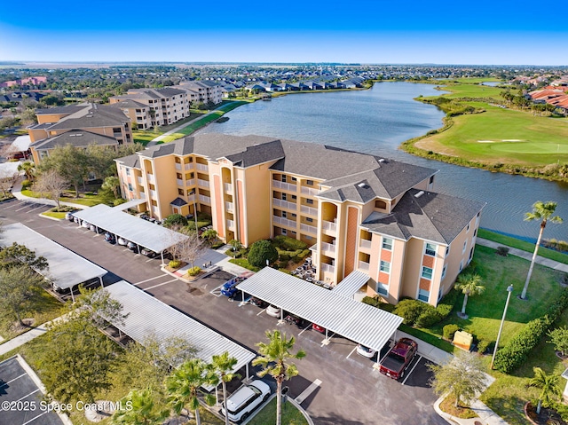 birds eye view of property with a water view and golf course view