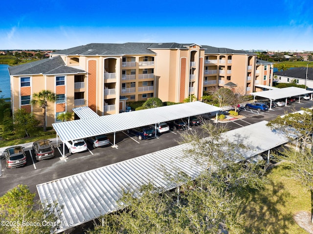 view of building exterior with uncovered parking