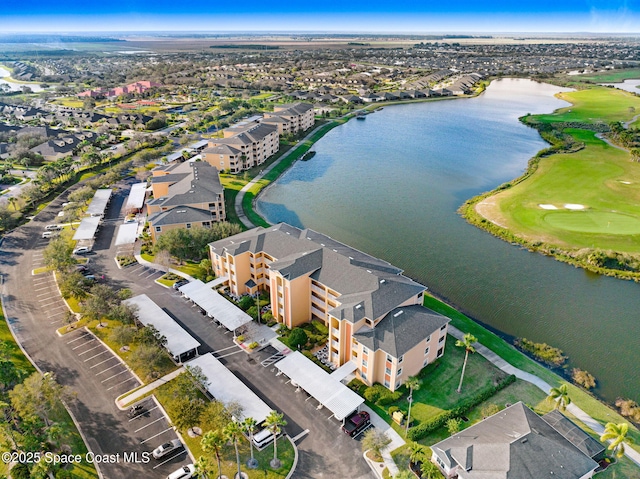 drone / aerial view featuring a water view, a residential view, and golf course view