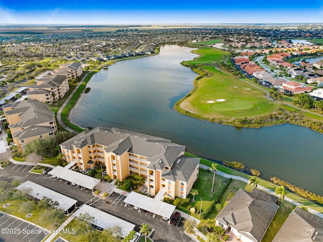 birds eye view of property featuring a residential view, view of golf course, and a water view