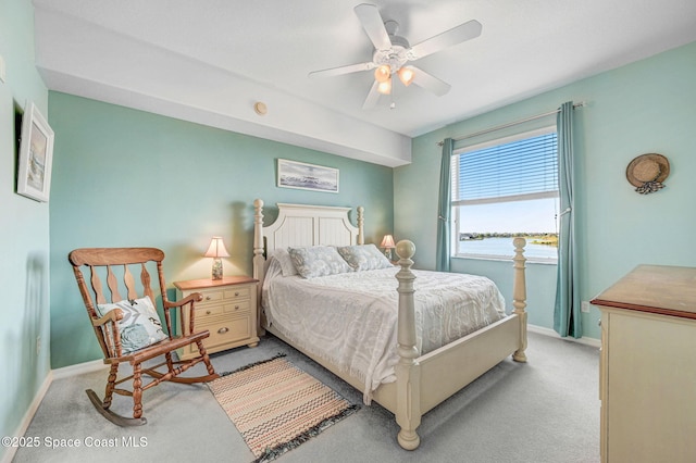 bedroom featuring baseboards, a ceiling fan, and light colored carpet