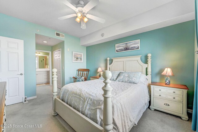 bedroom with light colored carpet, visible vents, a ceiling fan, ensuite bath, and baseboards