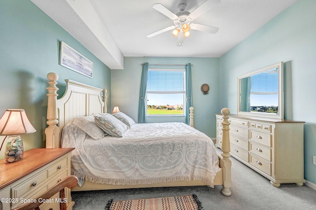 bedroom with a ceiling fan and light colored carpet