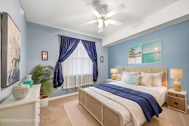 bedroom with light carpet, baseboards, and a ceiling fan