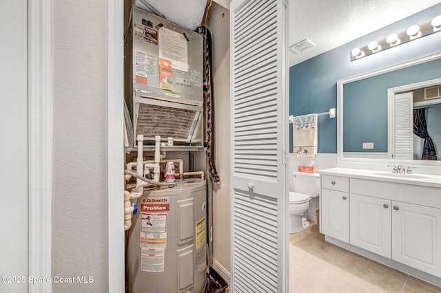 utilities featuring water heater and a sink