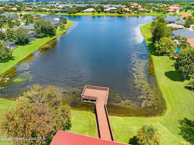 drone / aerial view featuring a water view and a residential view