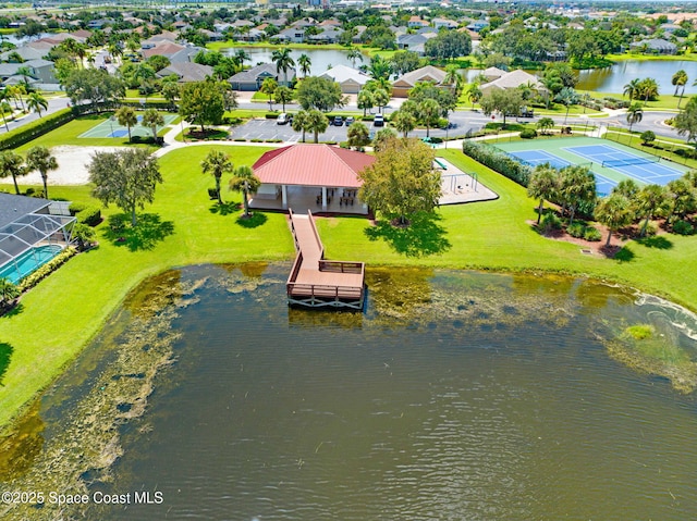 drone / aerial view featuring a water view and a residential view