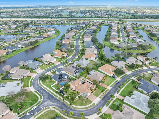 bird's eye view featuring a water view and a residential view