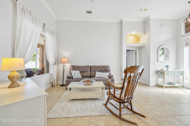 living area featuring baseboards, visible vents, ornamental molding, and light tile patterned flooring