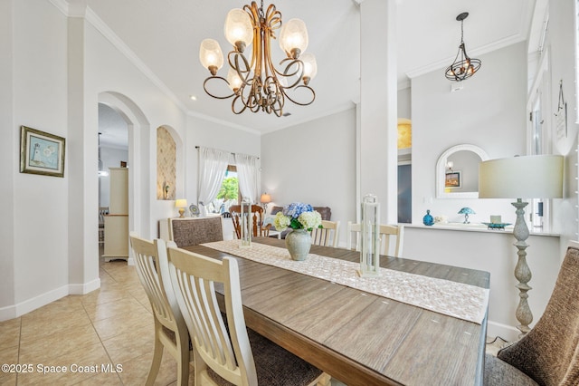 dining room featuring light tile patterned floors, baseboards, arched walkways, and crown molding