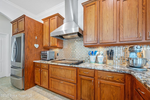 kitchen with arched walkways, light stone counters, black electric stovetop, extractor fan, and smart refrigerator