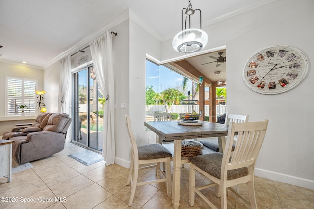 dining area with light tile patterned floors, baseboards, and crown molding