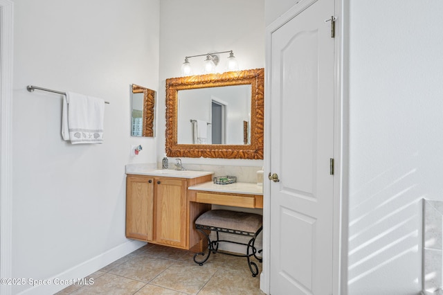 bathroom with tile patterned flooring, baseboards, and vanity