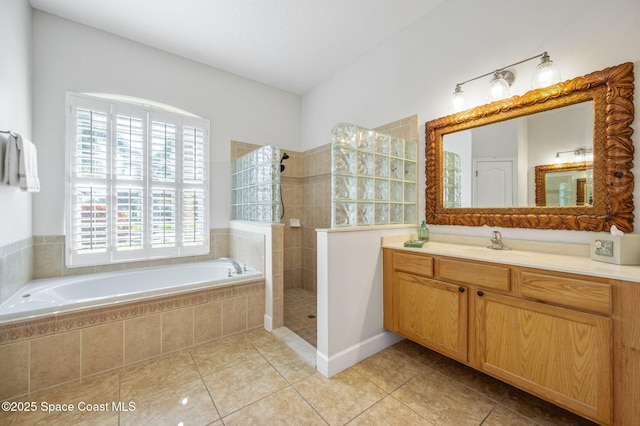 full bathroom featuring tile patterned floors, a garden tub, vanity, and a walk in shower