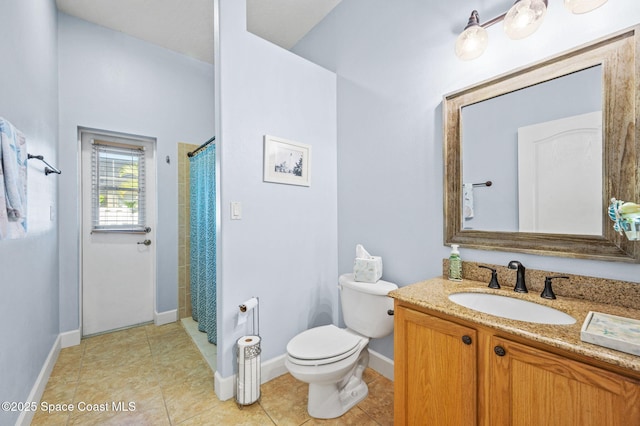 bathroom featuring tile patterned flooring, a shower with shower curtain, vanity, and toilet