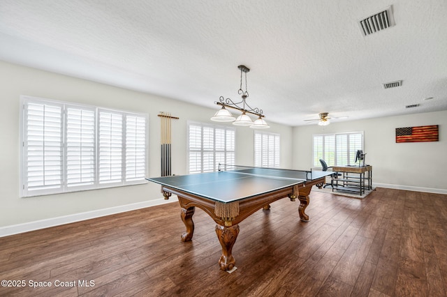 game room with visible vents, dark wood finished floors, a textured ceiling, and baseboards