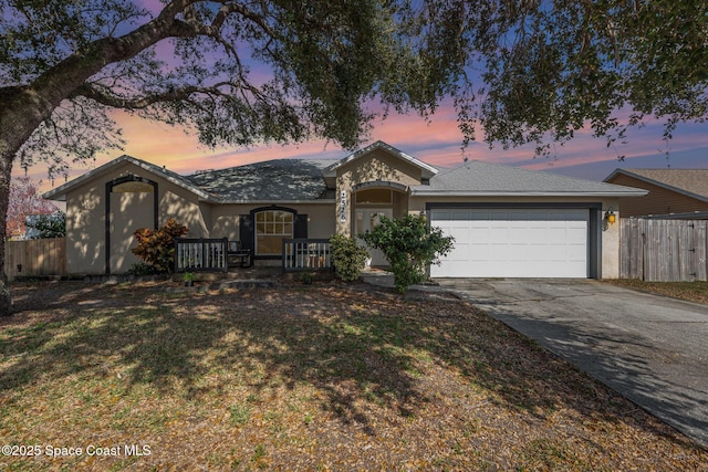 single story home with a garage and a yard