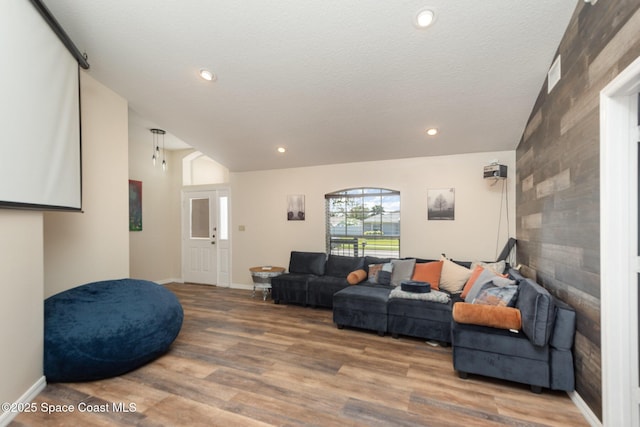 living room featuring wood-type flooring and a textured ceiling