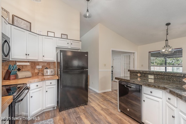 kitchen featuring hardwood / wood-style flooring, tasteful backsplash, black appliances, white cabinets, and decorative light fixtures