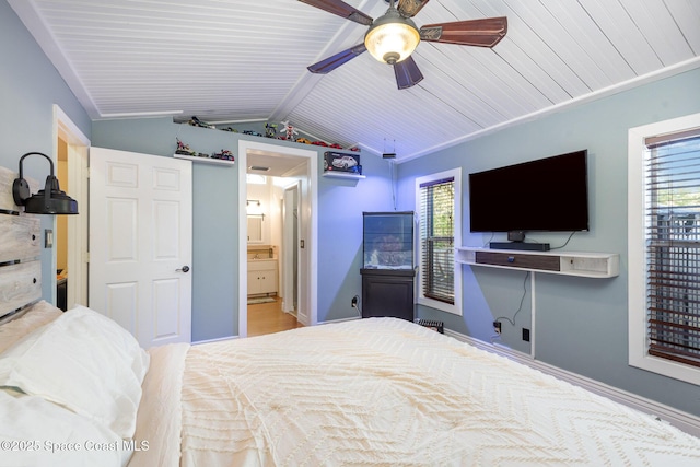 bedroom with lofted ceiling with beams, ceiling fan, and ensuite bath