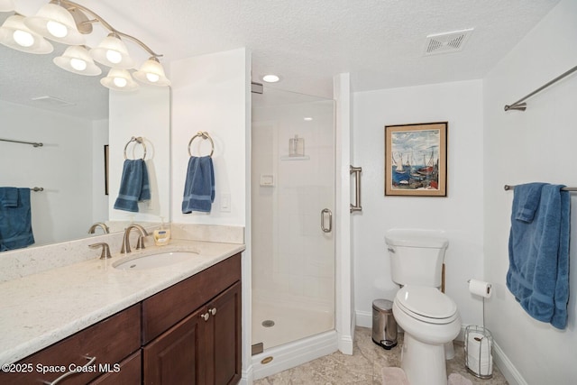 bathroom featuring a textured ceiling, toilet, vanity, visible vents, and a shower stall