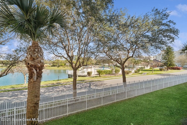 exterior space featuring a water view and fence