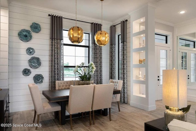 dining area featuring crown molding and hardwood / wood-style floors