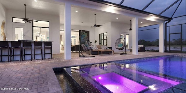 view of swimming pool with an in ground hot tub, ceiling fan, exterior bar, and a patio area