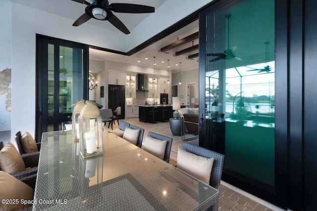 dining area featuring ornamental molding and ceiling fan