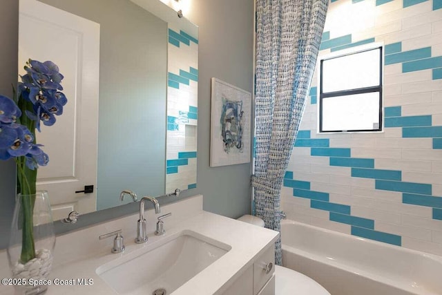 full bathroom featuring vanity, shower / bathtub combination with curtain, and toilet