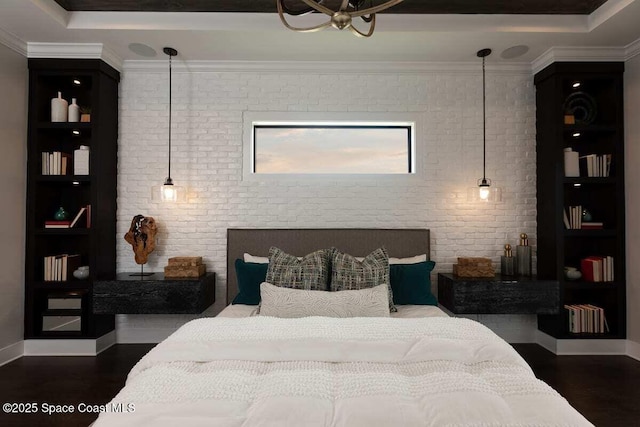 bedroom with dark hardwood / wood-style floors, ornamental molding, a raised ceiling, and brick wall