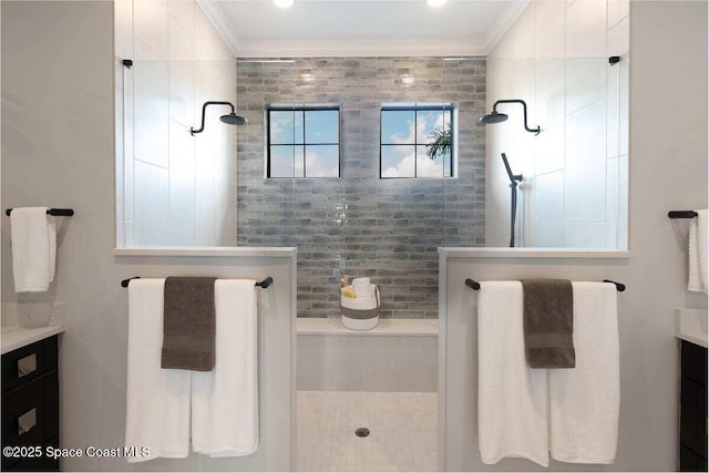 bathroom with vanity, ornamental molding, and a tile shower