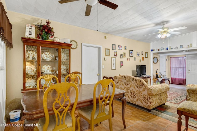 tiled dining space featuring ceiling fan