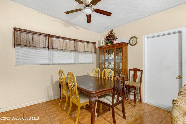 dining area featuring light tile patterned floors and ceiling fan