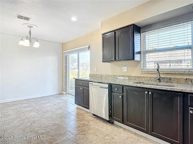 kitchen featuring sink, dishwasher, light stone counters, a textured ceiling, and decorative light fixtures