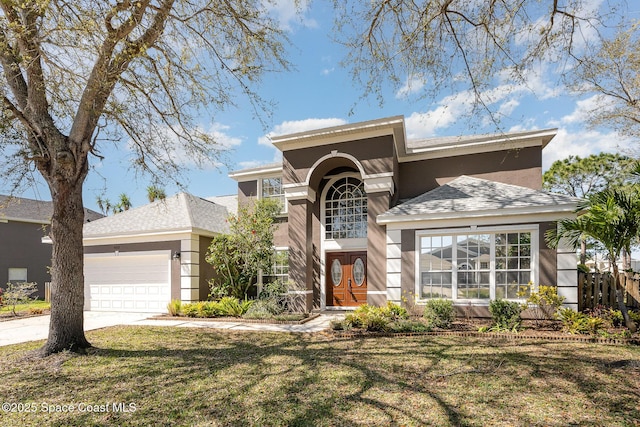 view of front of house featuring a garage, concrete driveway, stucco siding, roof with shingles, and a front yard