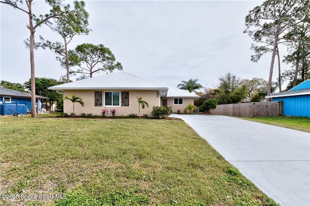 ranch-style home featuring a front yard