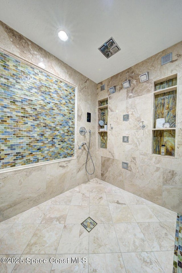 bathroom with tiled shower