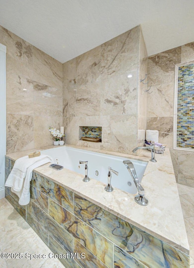 bathroom with tile walls and tiled tub