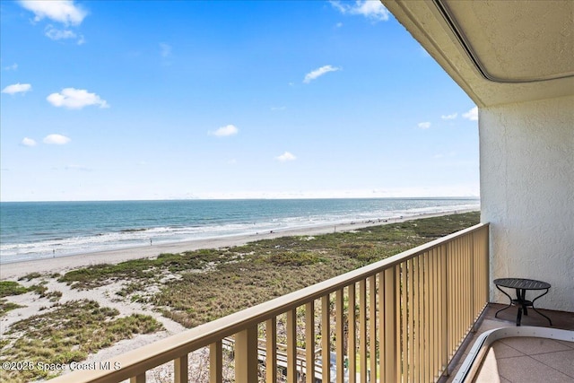 balcony with a view of the beach and a water view