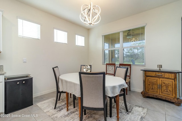 dining room with light tile patterned flooring and a notable chandelier