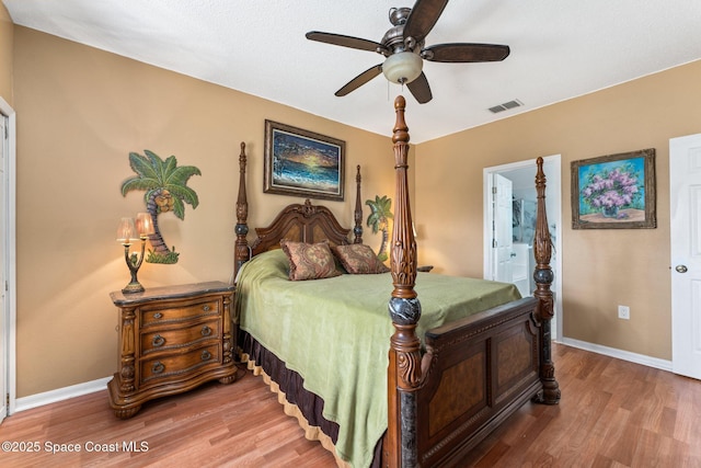 bedroom with ceiling fan, ensuite bath, and hardwood / wood-style floors