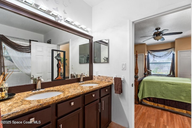 bathroom featuring vanity, hardwood / wood-style floors, a textured ceiling, and ceiling fan