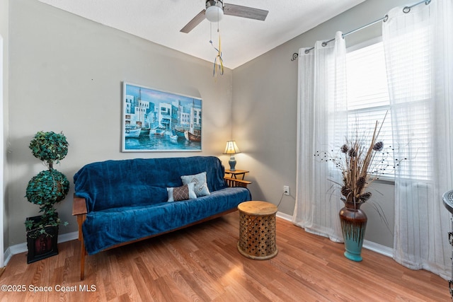 living room with wood-type flooring and ceiling fan