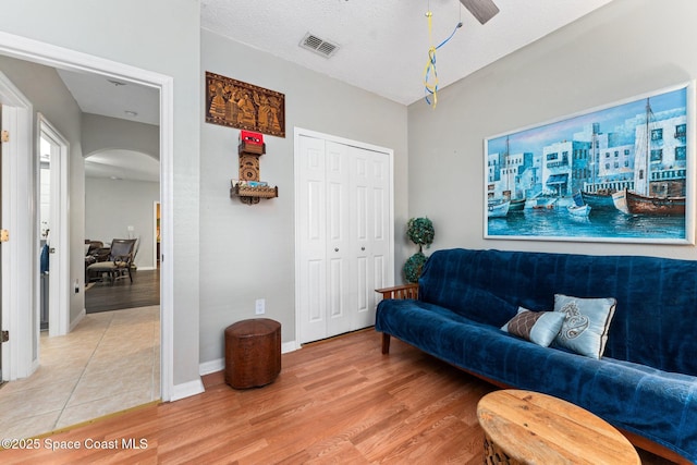 living room featuring hardwood / wood-style floors and a textured ceiling