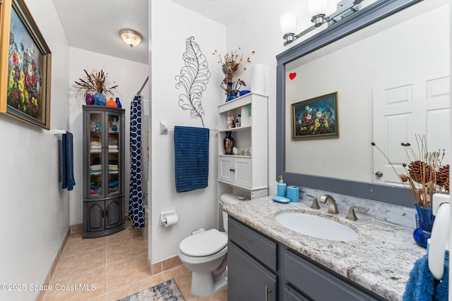 bathroom with tile patterned flooring, vanity, a shower with shower curtain, and toilet