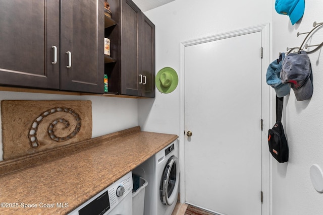 clothes washing area with cabinets